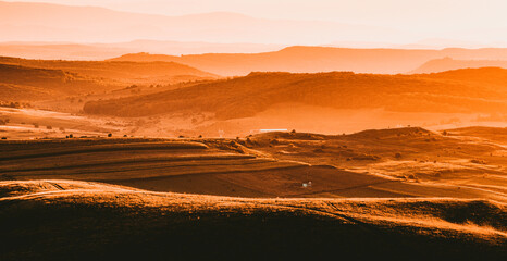 autumn landscape with hills in sunset light