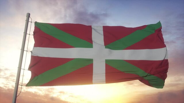 Basque Country flag, Spain, waving in the wind, sky and sun background