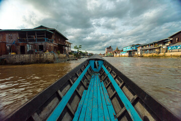 Fototapeta na wymiar Long Boat Navigating Inle Lake, Myanmar