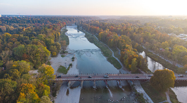 Aerial views of autumn in Munich. Isar river seen from above with colorful trees nearby