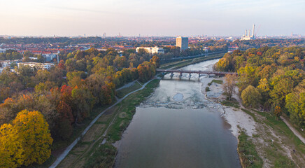 Aerial view of Isar river flowing into Munich and Thalkirchen bridge with cars in a beautiful...