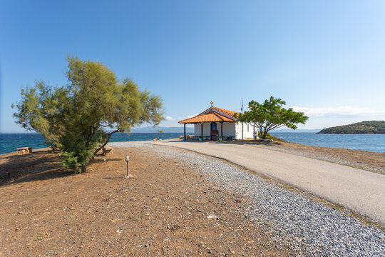 The Orthodox Church of St. Nicholas in Greece, on Kassandra peninsula in Halkidiki, Paliouri - Cape Kanistro. Summer day with clear blue sky in background.