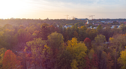 Beautiful evening in the city of Munich seen from above aerial drone image of Isar river next to German city