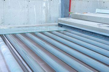 glass sheets on rollers. glass production factory