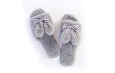 Slippers in the shape of a bunny with ears isolated on a white background, women's or children's indoor clothing, cute fluffy fur slippers home
