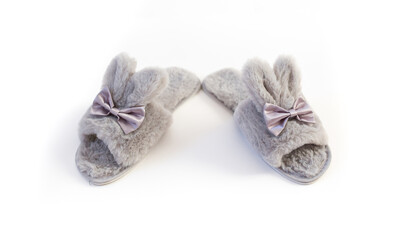 Slippers in the shape of a bunny with ears isolated on a white background, women's or children's indoor clothing, cute fluffy fur slippers home