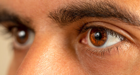 Macro photo of brown skinned man with brown eyes.
