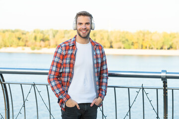 happy handsome unshaven man in checkered shirt listen music in headphones outdoor, ebook