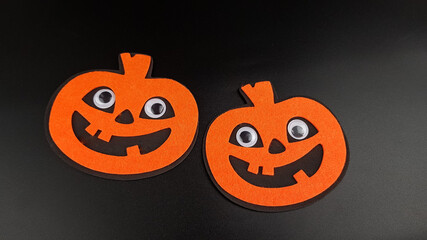 an image of cheerful orange pumpkins on a black background. there are places for a copy