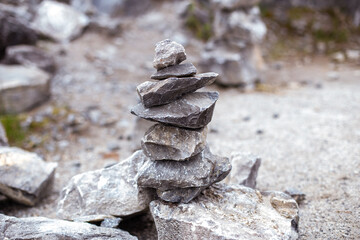 Pyramid of grey stones for meditation on forest background