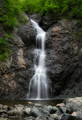Fototapeta na wymiar Silky smooth waterfall over the cliffs