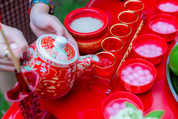 Traditional Chinese tea sets in wedding day. Pouring tea in a Chinese wedding. The Chinese text in...