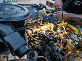 Mechanic repairing old engine with lighting