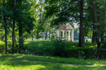 pergola in the shade of trees