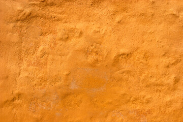 Isolated stone old wall with yellow plaster