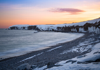 Sunset along the ice cave lined cliffs