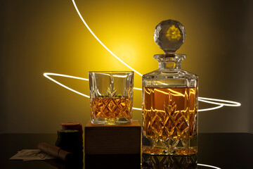 cognac brandy on gold yellow background in the glasses and decander