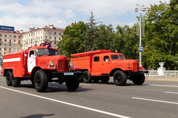 Fototapeta premium old fire trucks on the city street