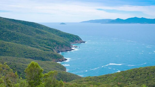 Baratti bay near the etruscan city of Populonia, known for necropoleis, old ruins, castle, sea and suggestive itineraries in Maremma park, between beaches and nature. 4K CINEMATIC CAMERA RAW FOOTAGE