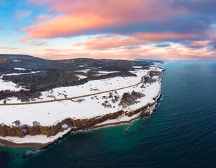 Pastel colored sunset over the winter coastline