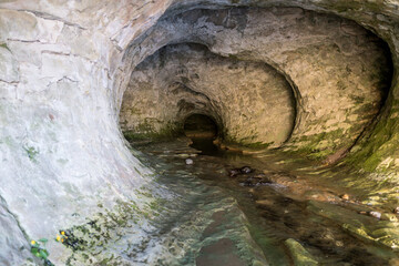 River Running Through a Dark Limestone Cave. Cave Stream, Castle Hill Basin, New Zealand