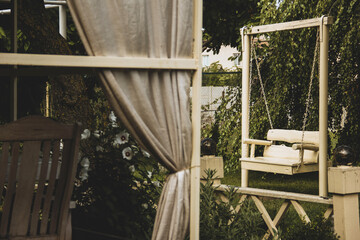 White wooden swing in the garden. Romantic place