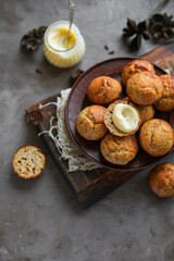 Lemon muffins with poppy seeds on a plate. Creamy half cupcake
