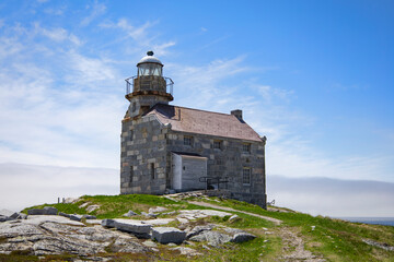Fototapeta na wymiar Old granite brick lighthouse