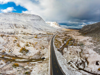 First snowfall on the golden autumn trees