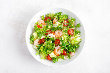 Shrimps, tomato and avocado summer vegetable salad with fresh lettuce, rocket and sesame. Healthy...