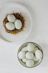 Easter flat lay with green eggs on a white marble