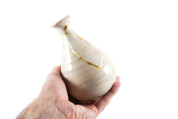 Antique Japanese Kintsugi, beige Kintsugi vase restored with gold cracks. Wabisabi pottery