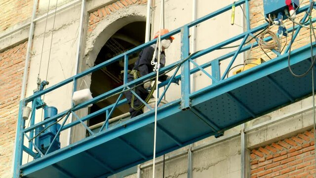 Industrial workers welding metal structures, male welders brazing a steel beam on a new building at a construction site. the welder is working. Sparks fly like a welder welds steel. builder