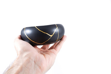 Antique Japanese Kintsugi, brown and black Kintsugi bowl restored with gold cracks. Wabisabi pottery