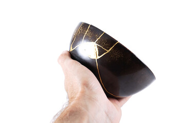 Antique Japanese Kintsugi, brown black Kintsugi bowl restored with gold cracks.