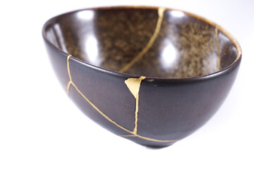 Antique Japanese Kintsugi, brown black Kintsugi bowl restored with gold cracks.