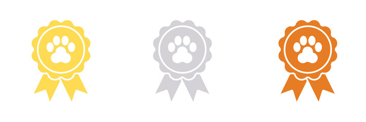 Gold, silver and bronze ribbon award dog rosettes for 1st, 2nd, and 3rd place winners with a dog's paw print in the center