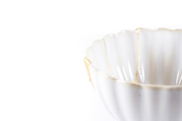 isolated Japanese kintsugi bowl restored with real gold cracks