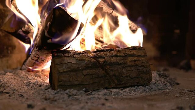 Firewood burning in the fireplace. A blazing fire inside the stove. Beautiful burning of palen