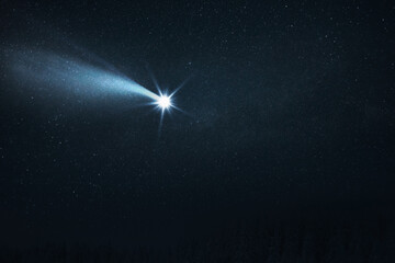 Comet flies in the starry sky at night. Falling glowing star. Christmas holidays concept. Space...