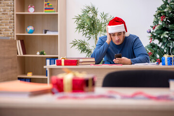 Young male student preparing for exams during new year celebrati