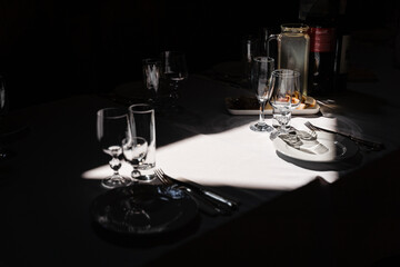 Glasses, plate and cutlery on the table. Table setting in the restaurant.