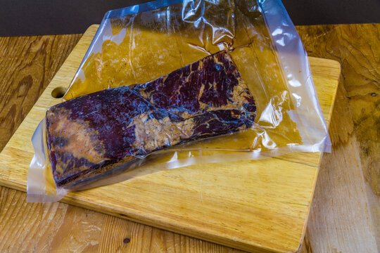 Home dry cured and smoked streaky bacon joint, vacuum sealed.
