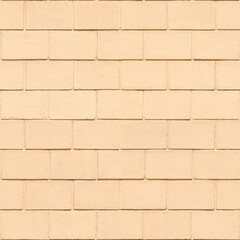Concrete block wall painted with light peach-orange paint. Seamless pattern. Brickwall background.