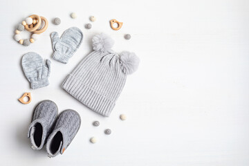 Collection of cute organic  baby clothes and booties. Warm hat, mittens and boots for cold weather of fall and winter season. Newborn gifts for Christmas and baby shower, donation idea.