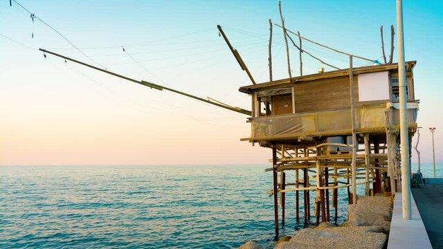 Trabocco San Giacomo in Ortona at sunset, Abruzzo. Trabucco a sort of Trebuchet, traditional wooden fishing house in southern Italy, on Costa dei Trabocchi (Coast Of the Trabocchi). CAMERA RAW FOOTAGE