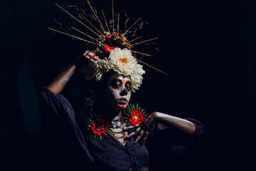 Woman with mexican halloween makeup on her face. Sugar skull day of the dead aka dia de las muertas