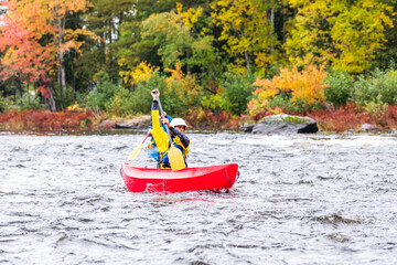 A solo canoeist practices strokes on a rainy fall day during  a &ldquo;moving water&rdquo; paddling course. Shot at Palmer Rapids on the Madawaska River an iconic paddling destination in Eastern Ontario, Canada