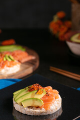 Puffed rice spread with raw salmon and avocado