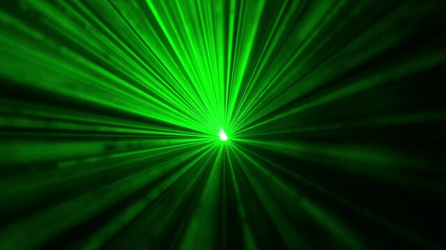 The laser pointer shining in darkness with a green light. slow motion